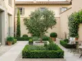 Giardino curato con ulivo centrale, aiuole geometriche e fontana. Belle idee muretto giardino per definire gli spazi.