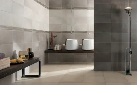 Bagno moderno con lavabi bianchi sospesi, ideale per chi cerca idee su come rivestire un bagno con stile e funzionalità.