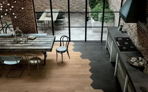 Un moderno spazio industriale dove accostare parquet e piastrelle esagonali crea un design unico.