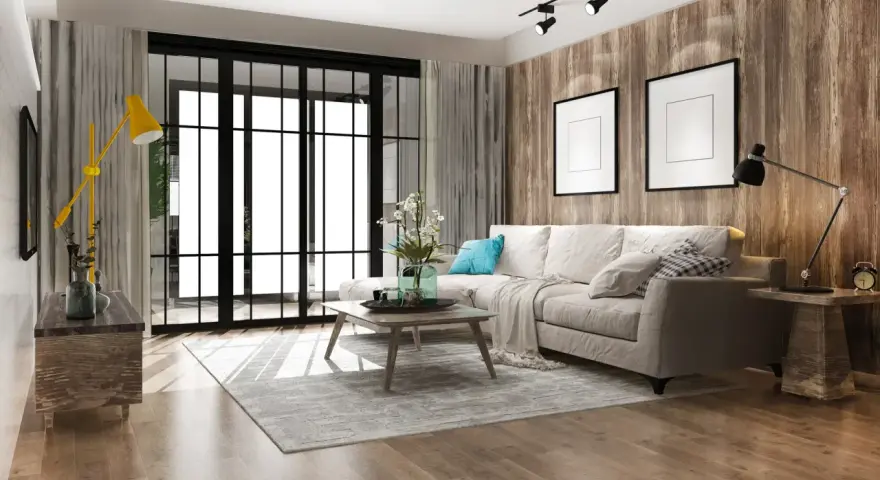 Soggiorno moderno con divano beige, tavolino in legno, lampada gialla e parete effetto legno. Un esempio di come ristrutturare appartamento con stile.