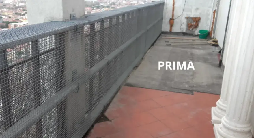 Il balcone è pronto per piastrellare su piastrelle esistenti. Si vedono attrezzi e un secchio, pronti per il lavoro.