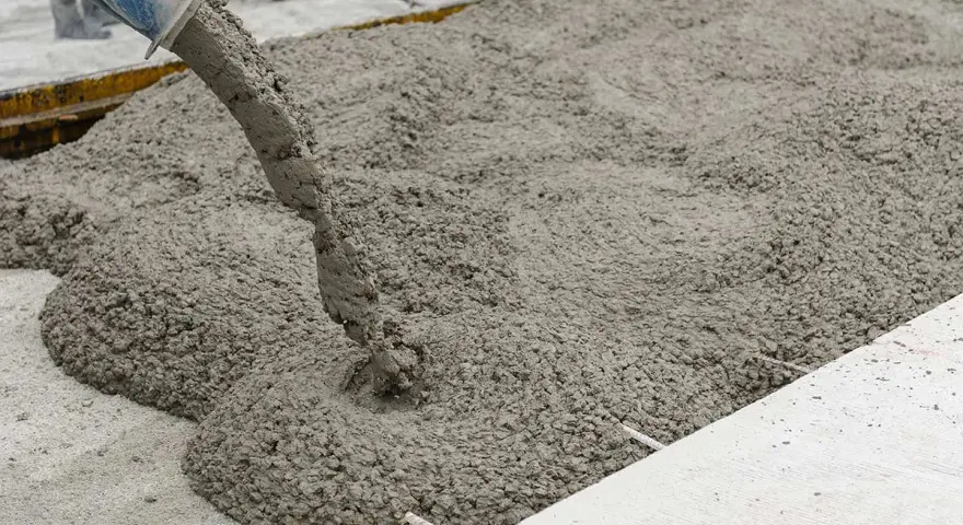 Calcestruzzo fresco versato da una pompa. La corretta tabella dosaggio calcestruzzo garantisce la qualità.